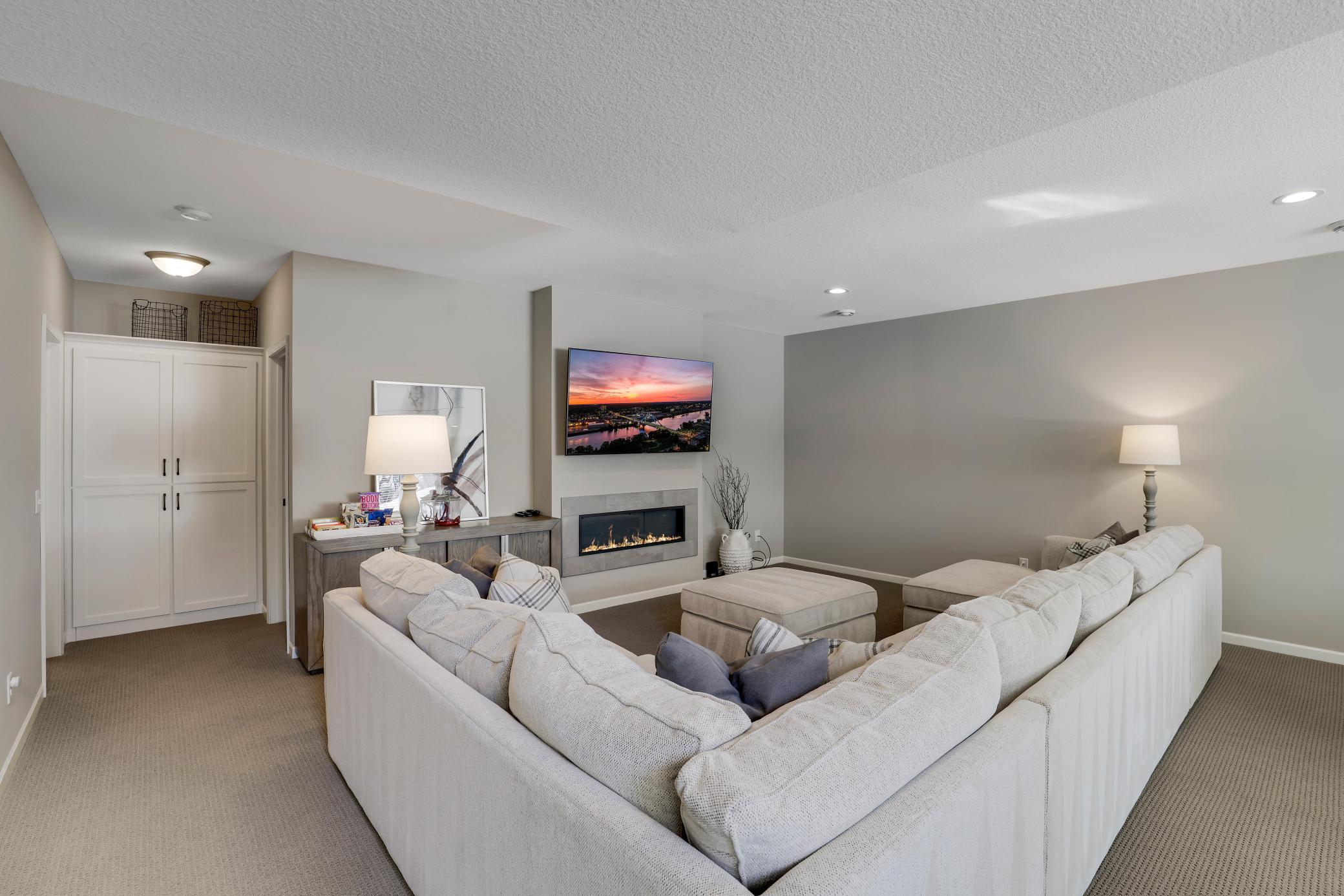 The gas burning fireplace is the focal point of this room with a sleek and modern design.