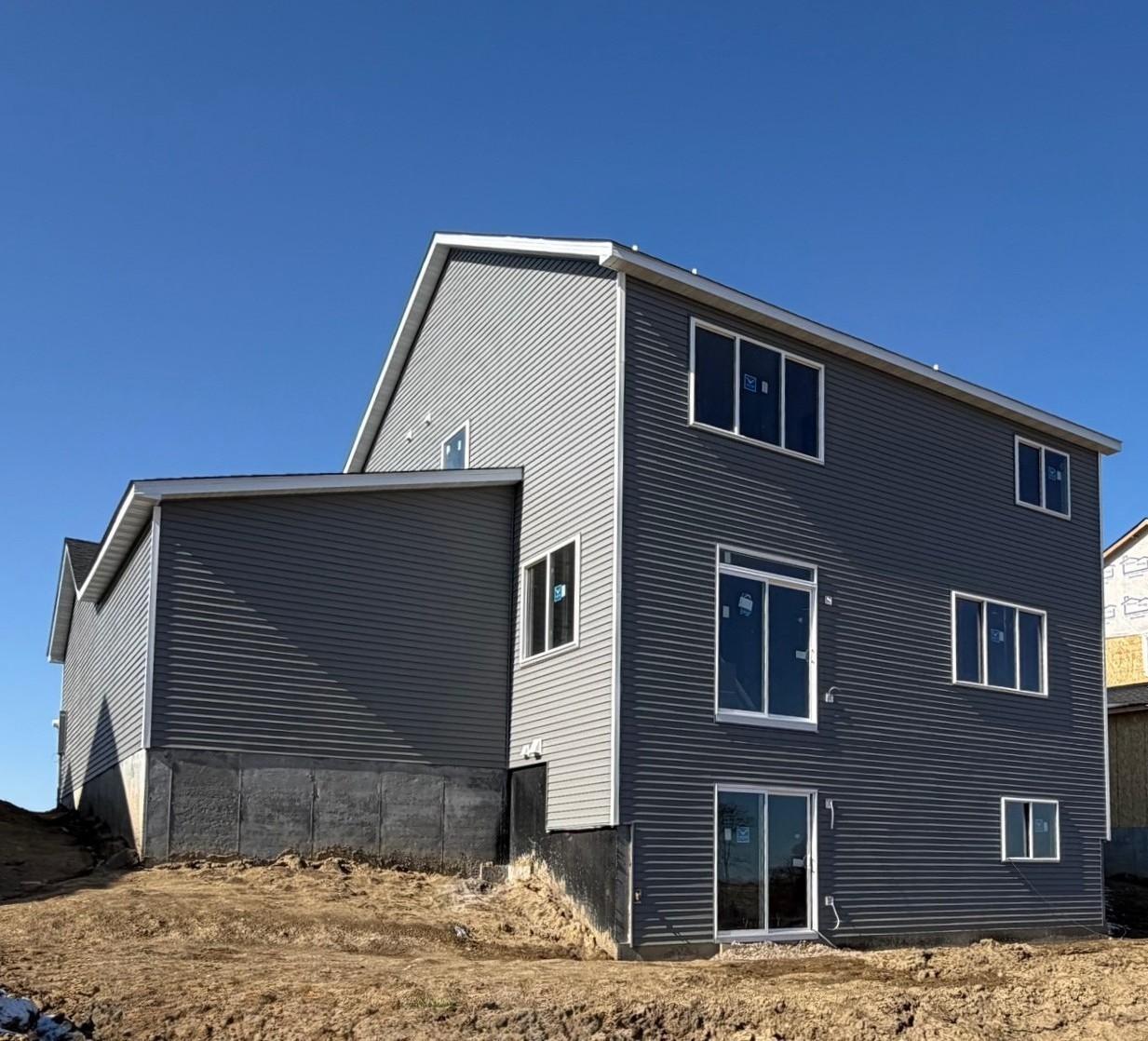 9686 32nd St NE- Photo of the rear elevation. Home features a walkout to the backyard.