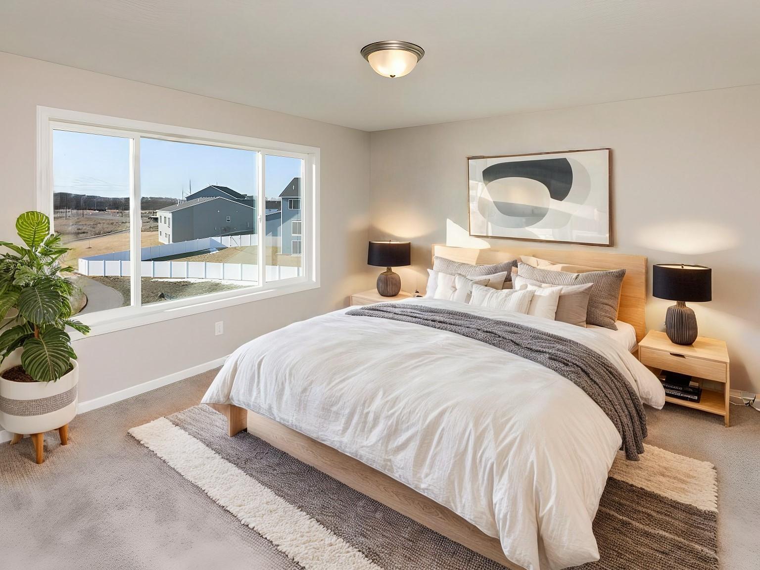 VIRTUALLY STAGED PHOTO OF A DIFFERENT HOME WITH SIMILAR PLAN. FINISHES MAY VARY. Primary Suite features large window with backyard views.