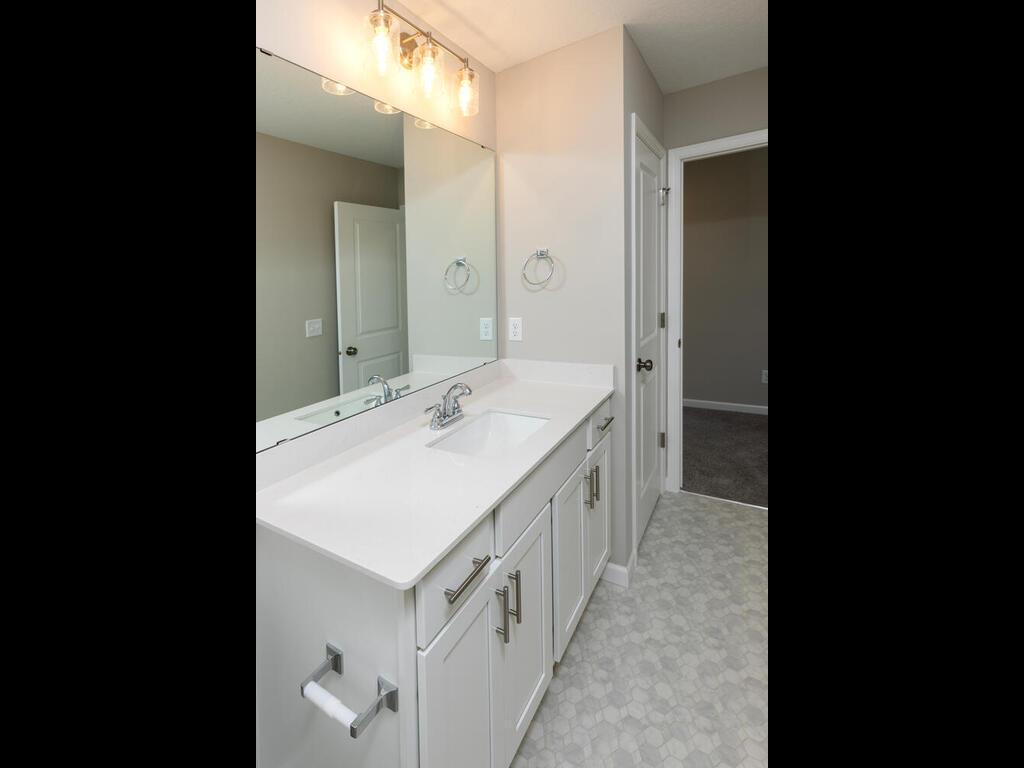 PHOTO OF A DIFFERENT HOME WITH SIMILAR PLAN. FINISHES MAY VARY. Upper Full Main Bathroom features a Linen Closet
