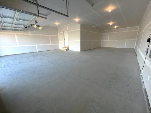 PHOTO OF A DIFFERENT HOME WITH SIMILAR PLAN & FINISHES. Spacious 4 BAY GARAGE (1,010 sq. ft.) offering an abundance of storage and work space!