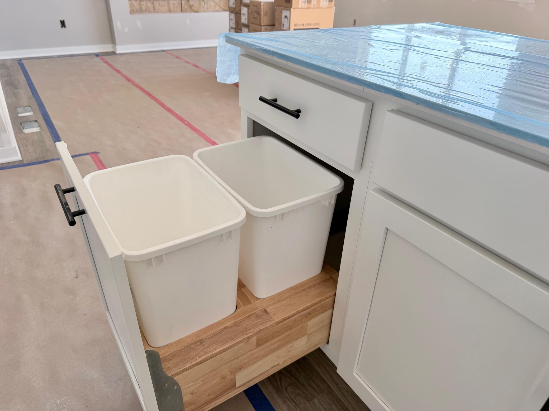 3171 Jandura Ave NE- Center Island features a Trash/Recycling cabinet pullout convenient to the kitchen sink.