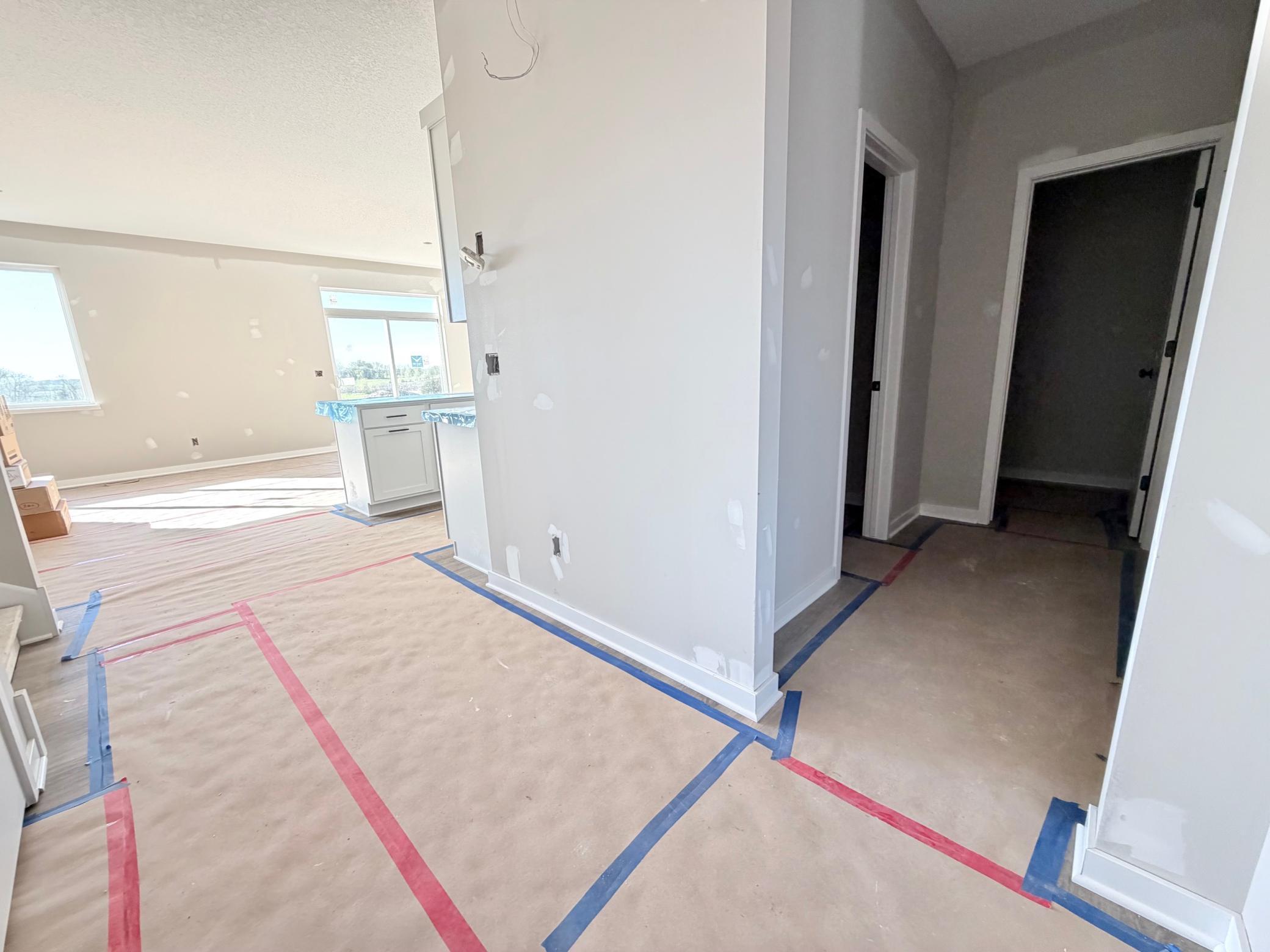 3171 Jandura Ave NE- Hallway view to the mudroom featuring a walk-in closet and half bath.