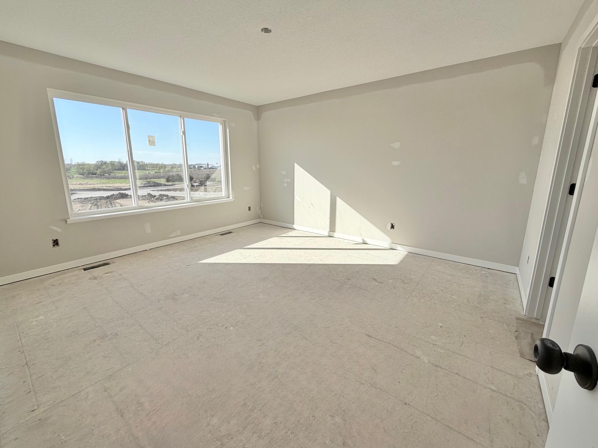 3171 Jandura Ave NE - Primary Suite features a Private Bath and Spacious Walk-in Closet with backyard views.