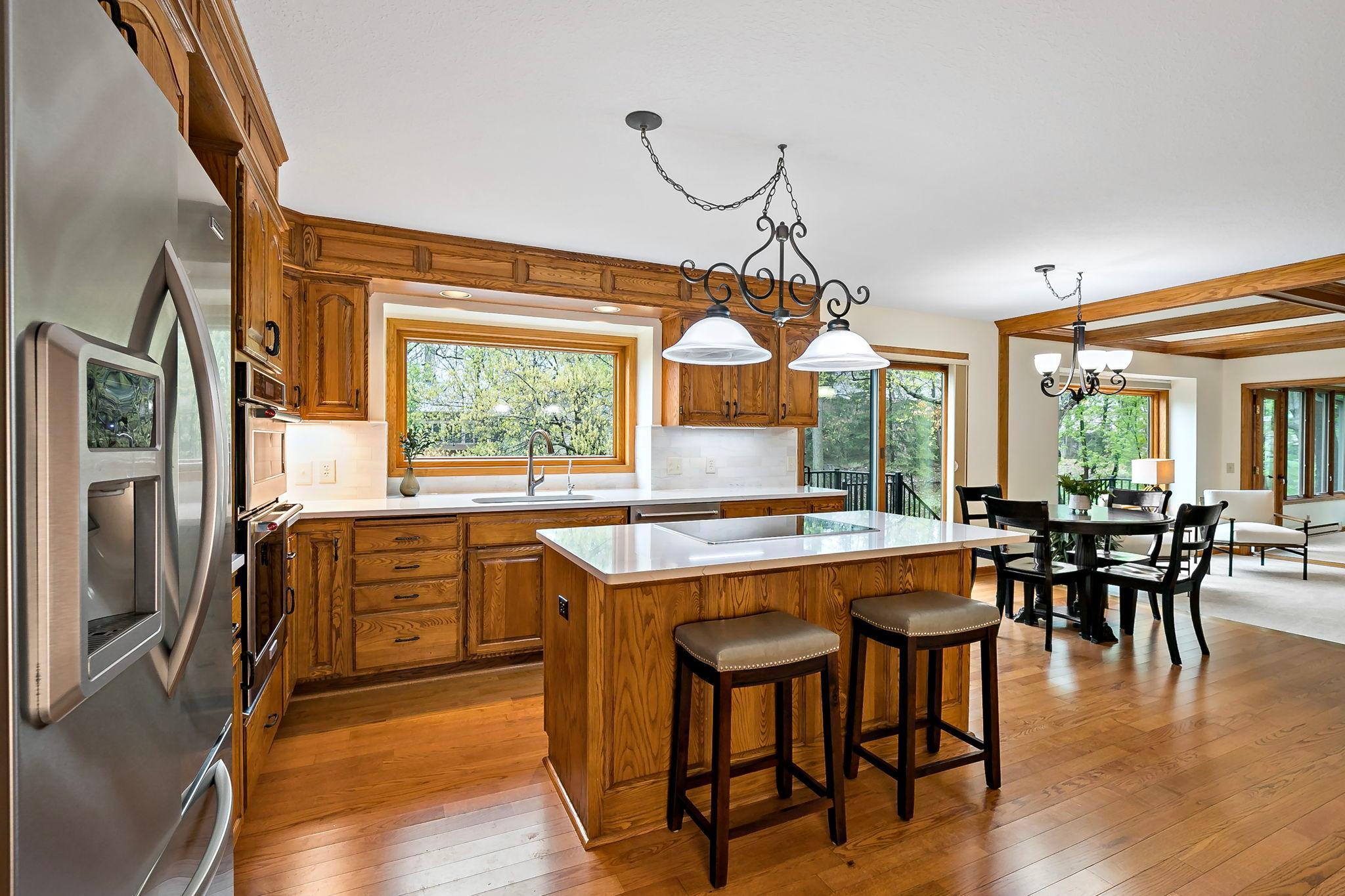 The kitchen, informal eating area and adjoining family room form the heart of the home.