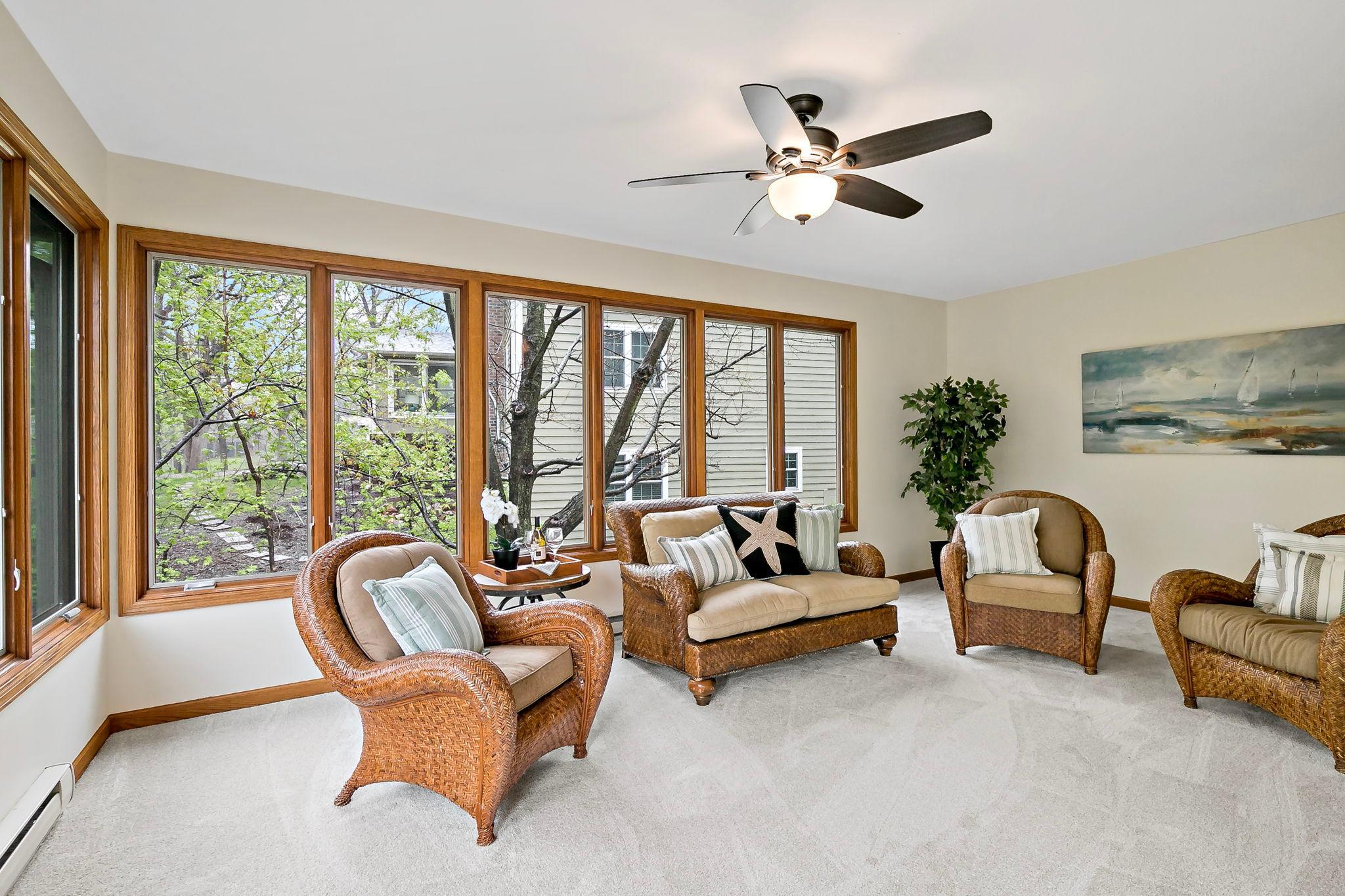 Enjoy a morning cup of coffee or a good book while sitting in this lovely sunroom. You'll stay cozy through the seasons with baseboard heat and Pella windows added when the space was enclosed.