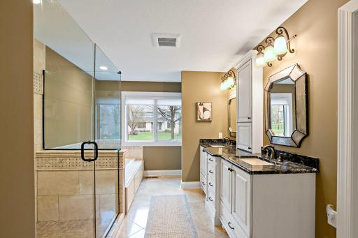 Absolutely fabulous total renovation of the primary bath was completed with dual sinks, soaking tub, and glass shower with custom tilework.