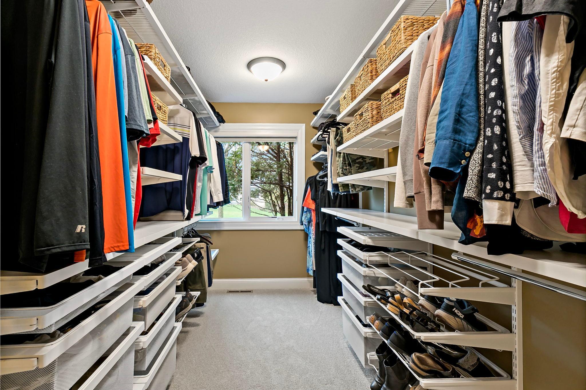 Huge walk-in closet with custom shelving.