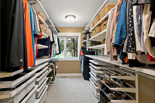 Huge walk-in closet with custom shelving.