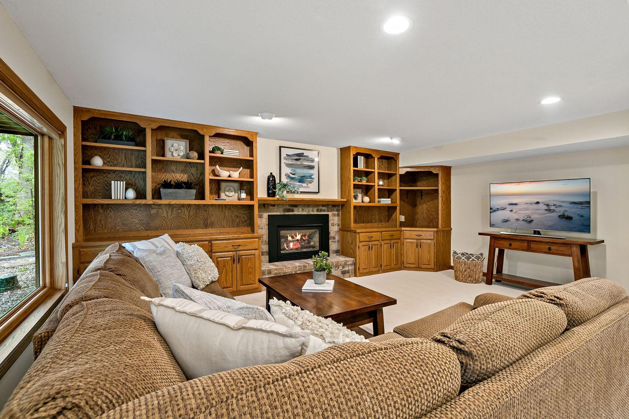 A cozy gas fireplace and loads of built-ins make for a great media or game center.