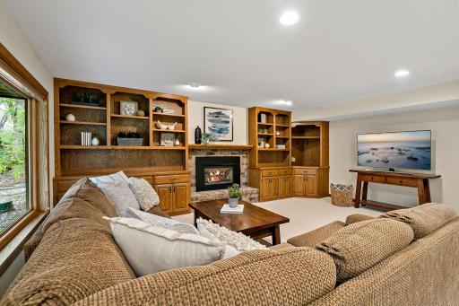 A cozy gas fireplace and loads of built-ins make for a great media or game center.