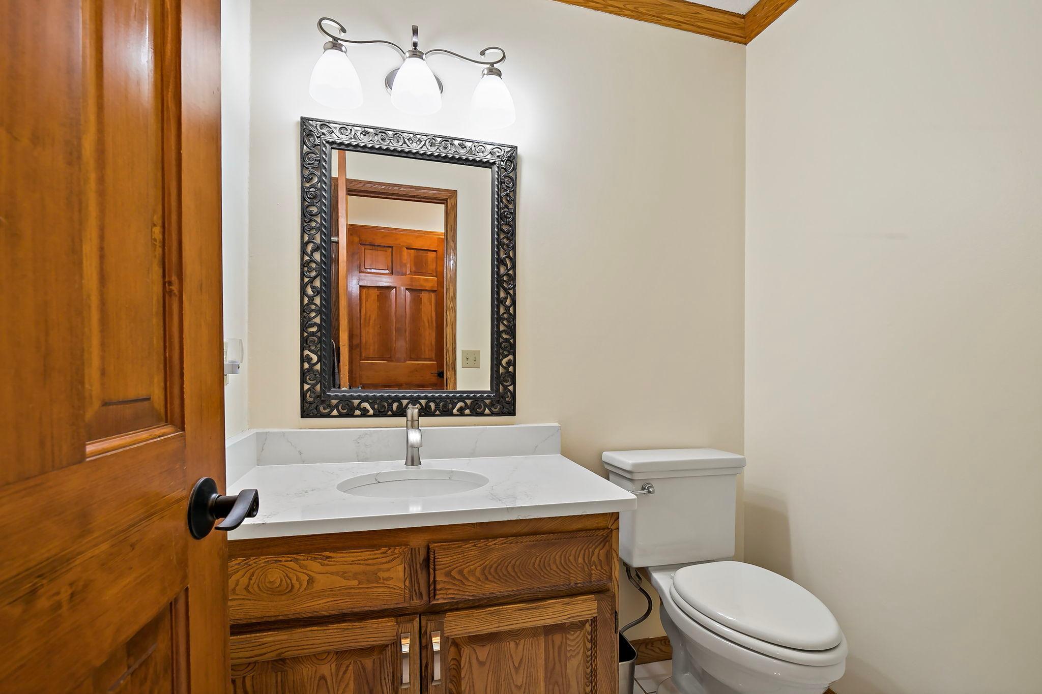 ....and a half bath with new quartz countertop, conveniently located just off the kitchen.