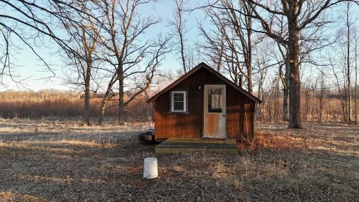 Small shed on property with wood burning fire place