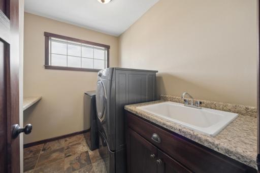 Convenient upper level laundry room also includes a sink