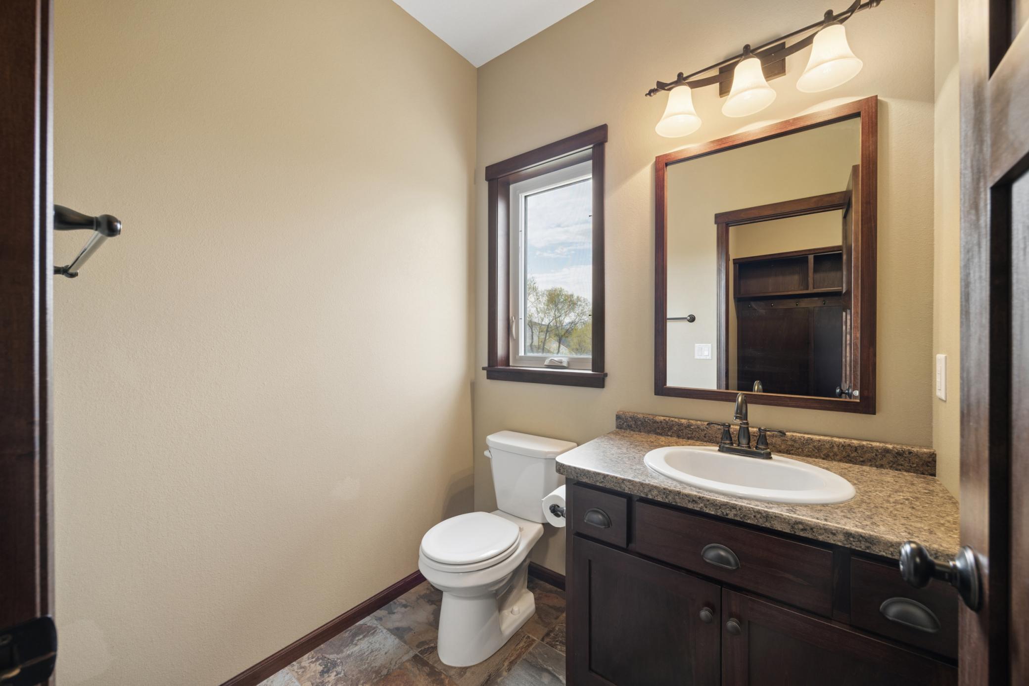 Adjacent half bath with a window to the backyard