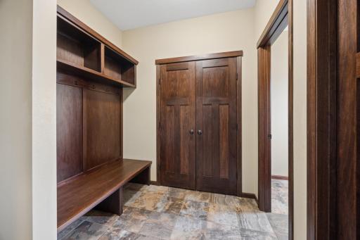 Thoughtfully designed mudroom, complete with built-in storage, access to the garage
