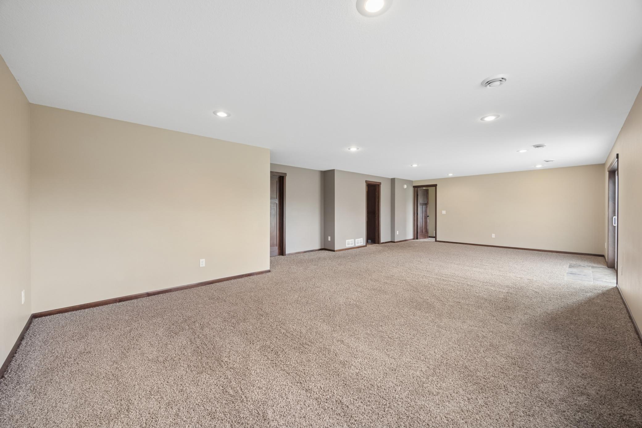 Recessed lighting and plenty of room for large furniture or even a pool table.