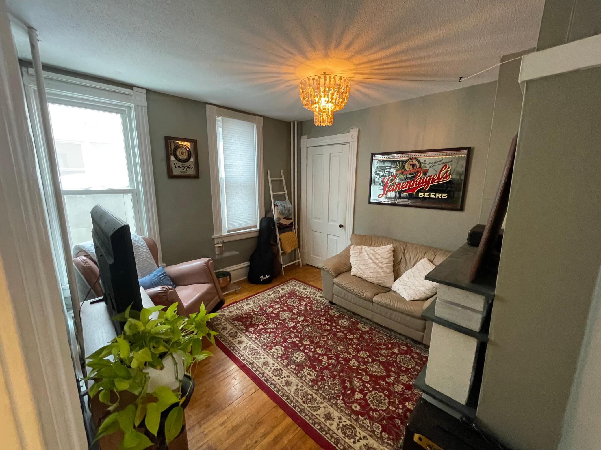 Living room facing door to bedroom