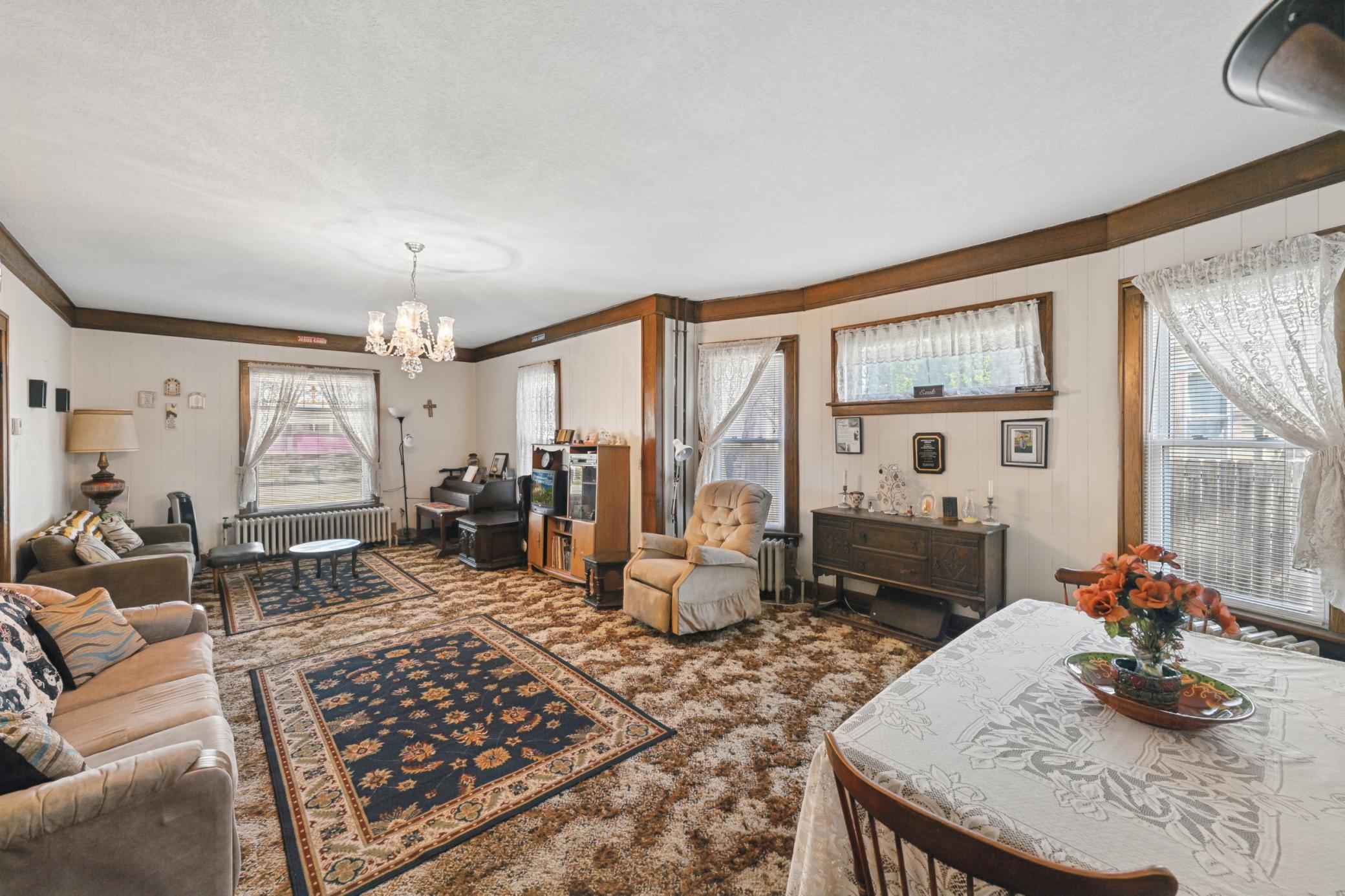 The living room features original trim. Beneath the current carpeting in the living and dining rooms lie original hardwood floors just waiting to be revealed.