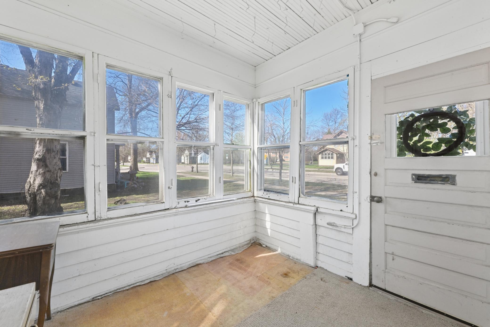 An enclosed porch is situated at the front of the house.