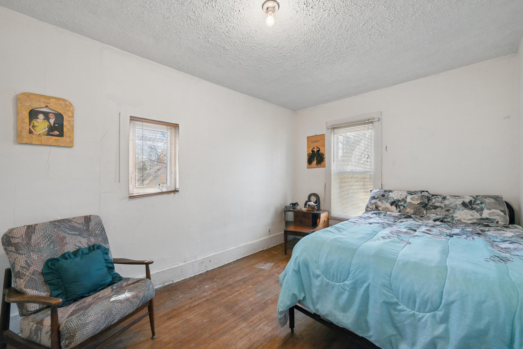 The fourth bedroom features hardwood flooring.