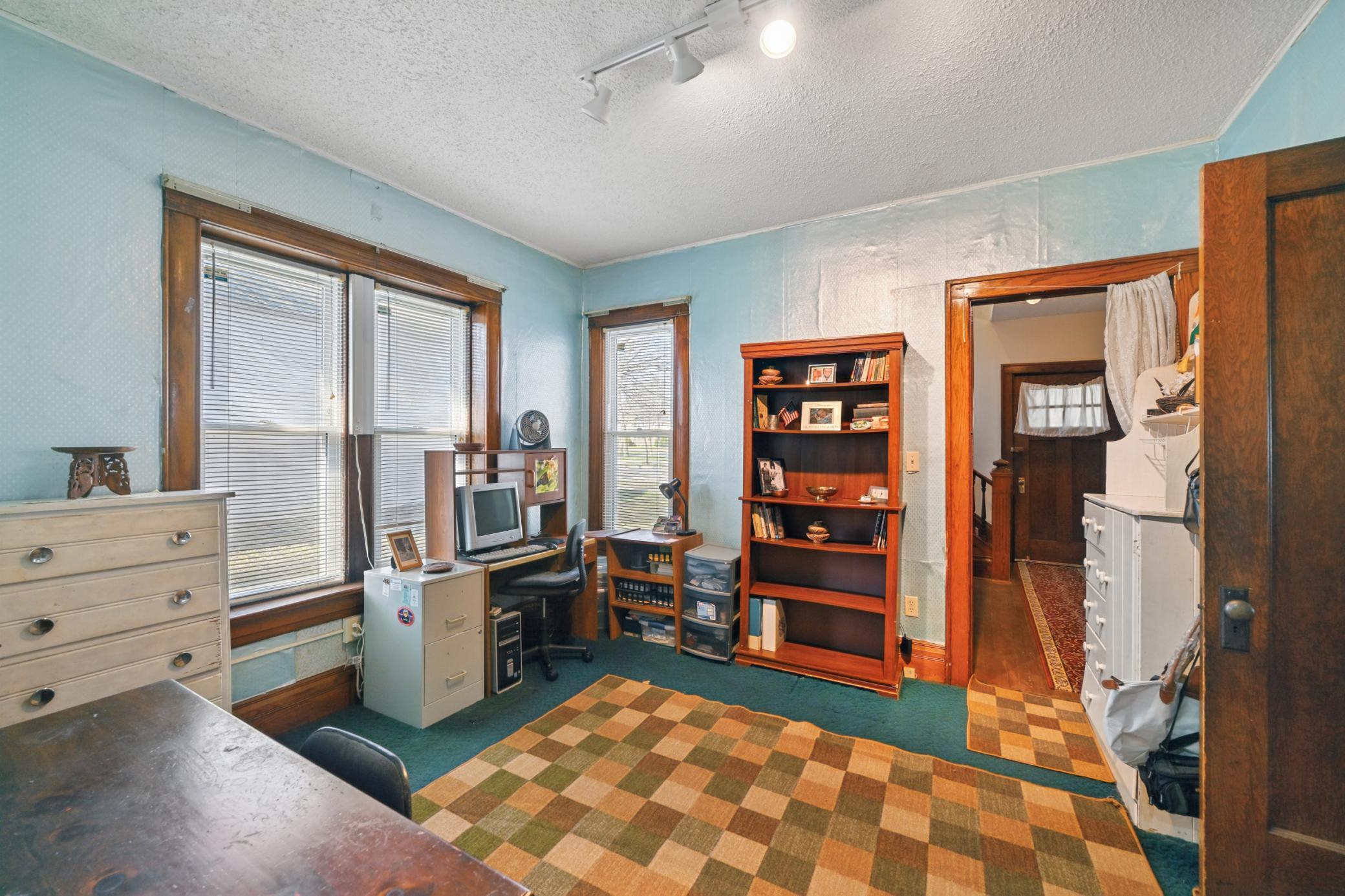 The main level offers a flexible layout with a main floor bedroom, currently being used as an office.