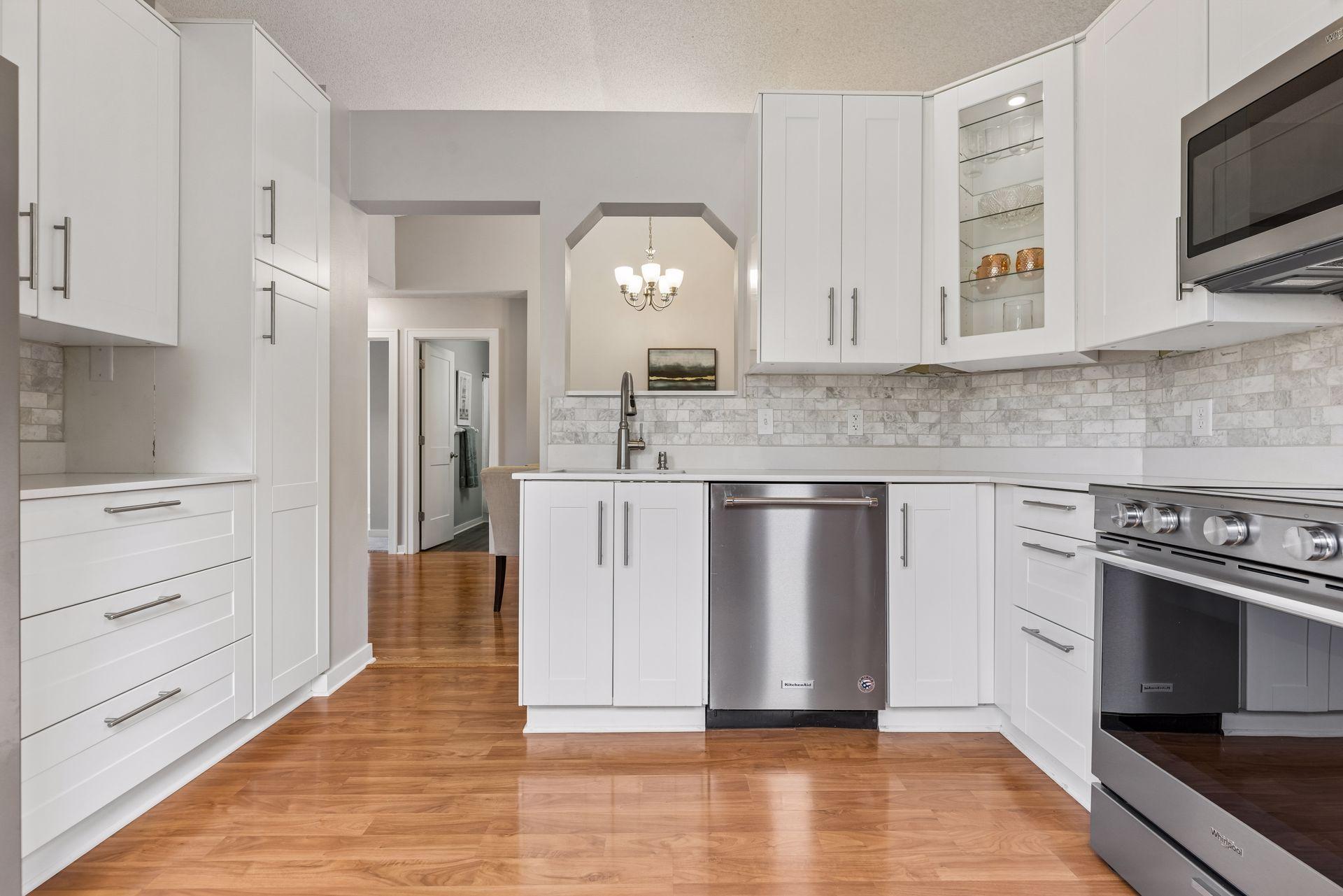 Quartz countertops and elegant marble backsplash