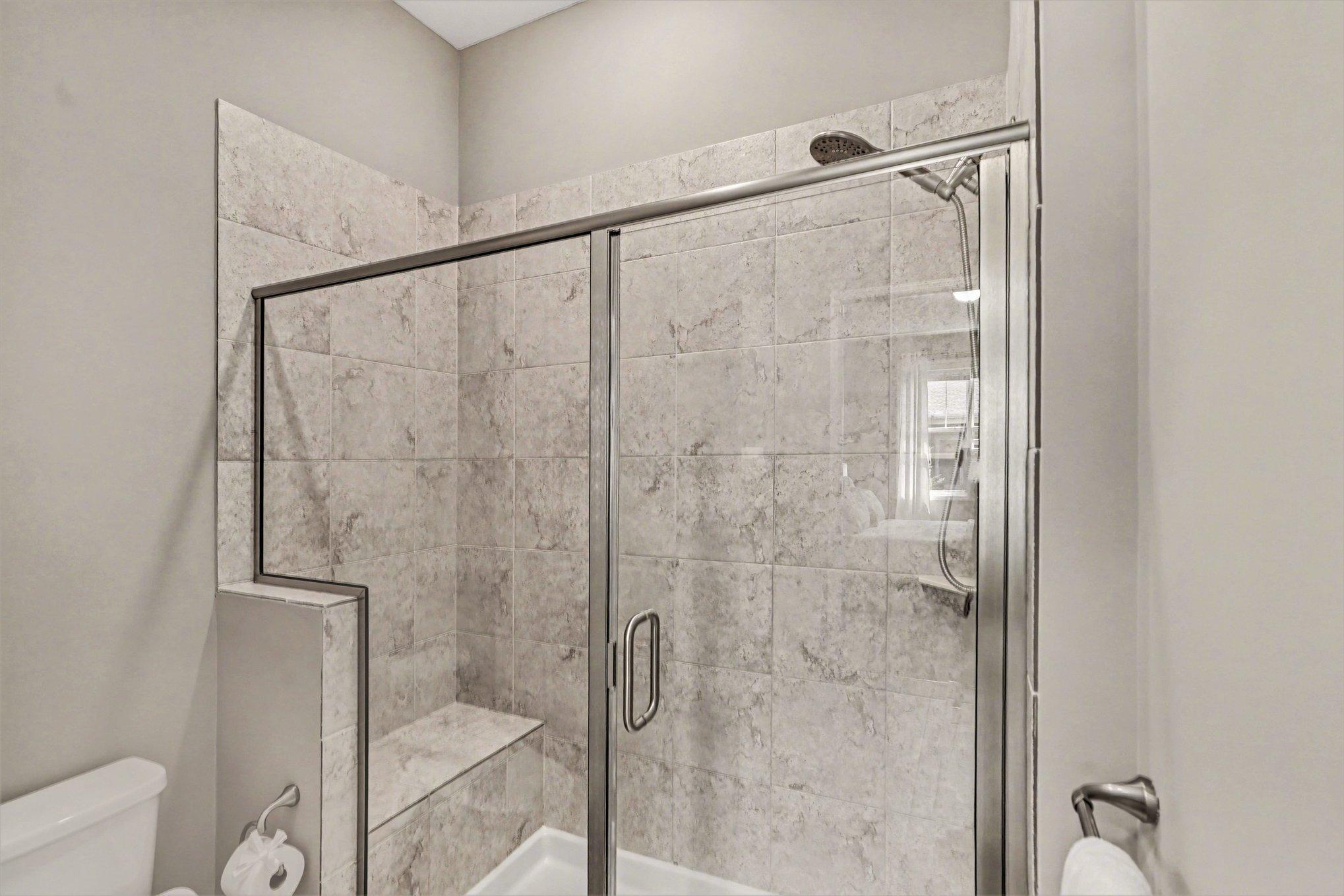 Large shower with a nice seat for taking a shower break!