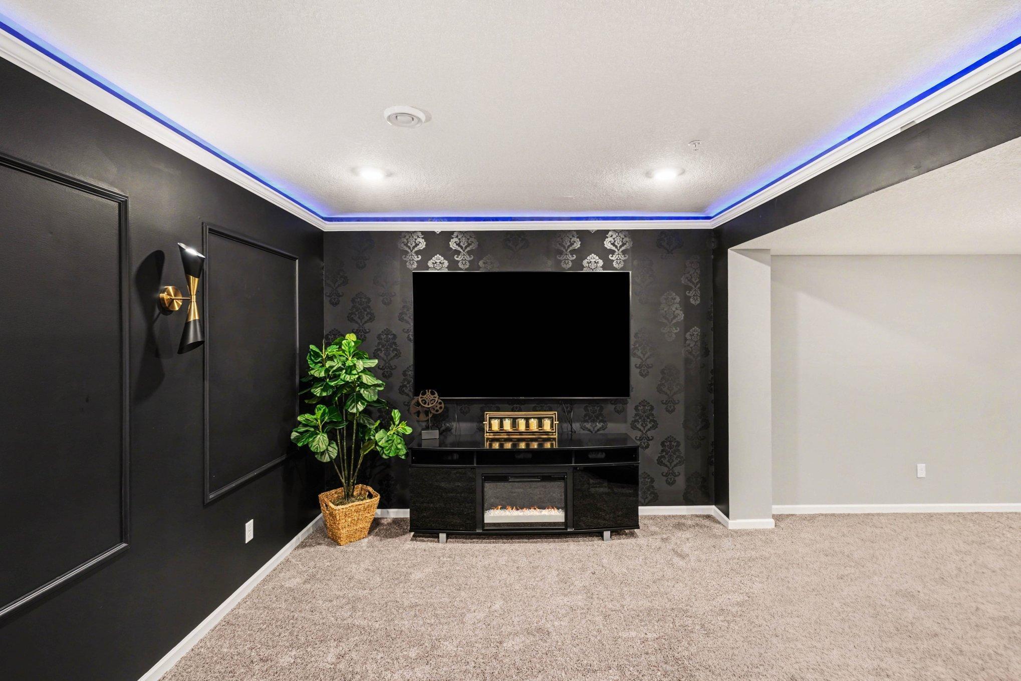 This classy wallpaper reminds you of being in a movie theatre and check out that overhead lighting!!