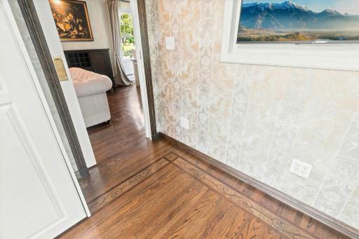 Tasteful, intricate walnut and maple inlays and two pockets doors round out the charm of this room.