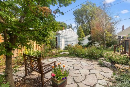 Heart-shaped custom flagstone Japanese garden is the perfect place to enjoy your morning coffee while watching the yearly pollinators and butterflies