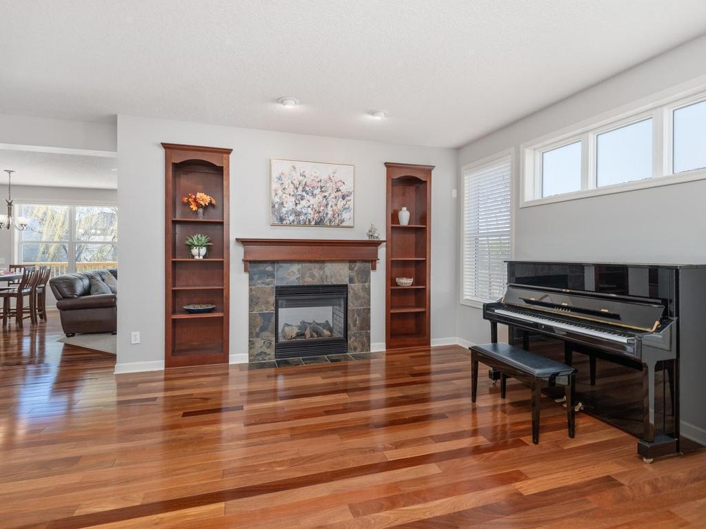 As you step in, the Living Room features hardwood floor, custom built-ins, and 2-sided fireplace shared with the Great Room.