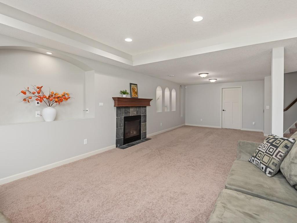 Huge lower-level Family Room has a gas fireplace and lighted alcoves for displaying your art.