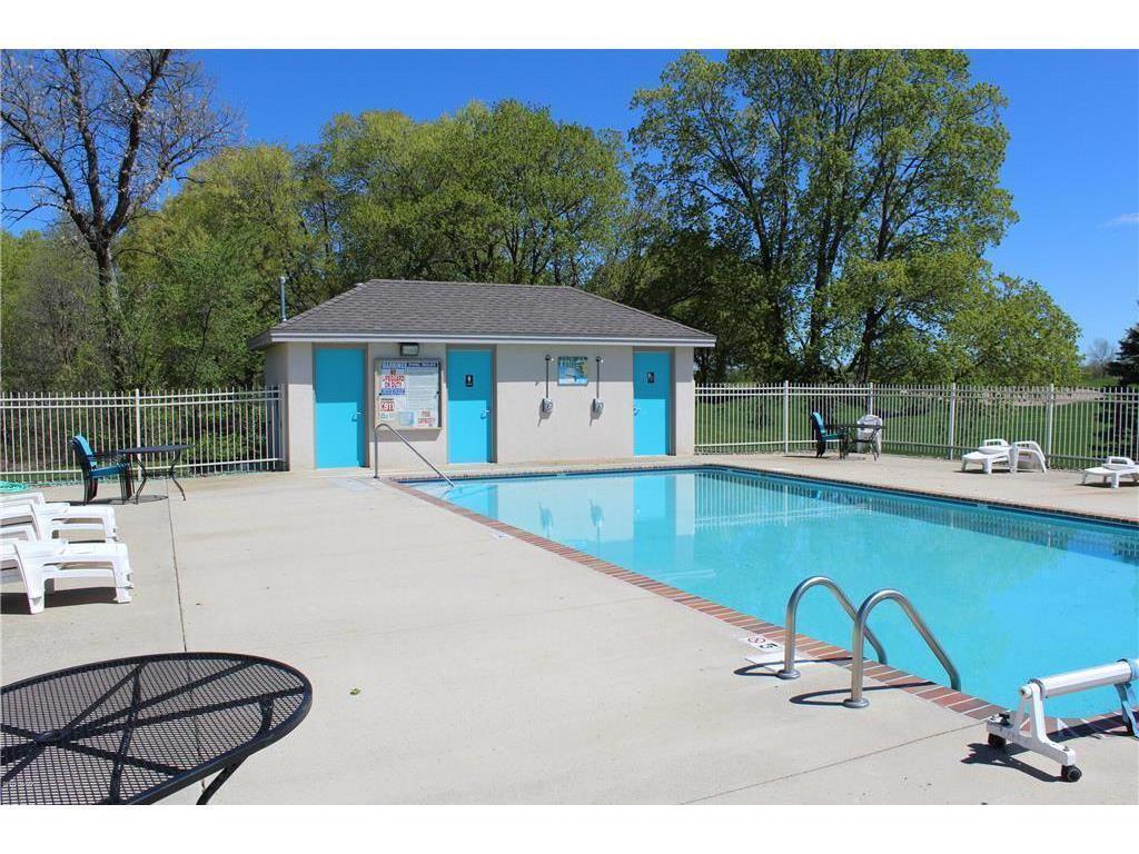 Large heated association swimming pool with patio and furniture and bathrooms