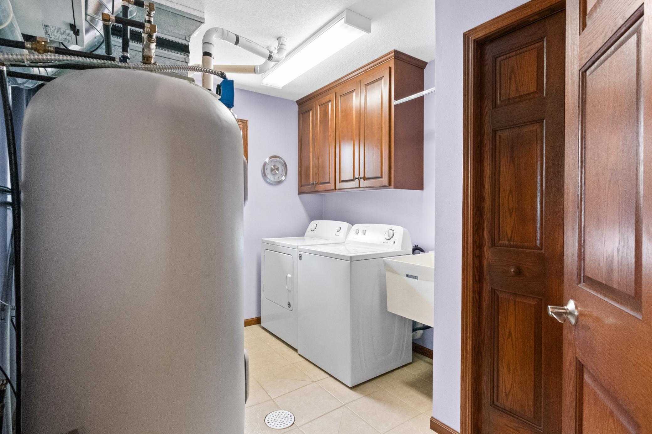 Laundry room with utility sink, large closet and cabinets