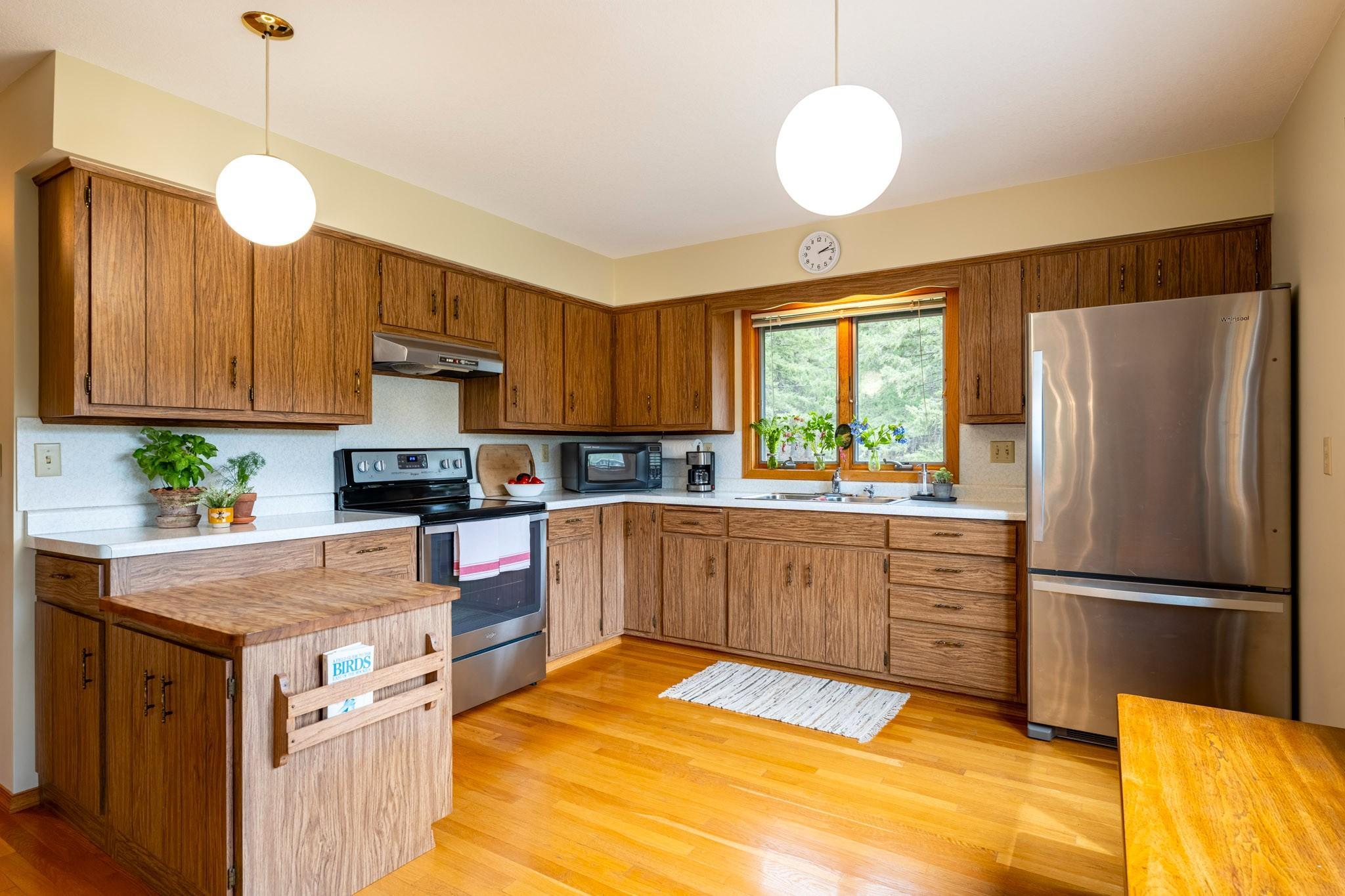 Spacious kitchen with hardwood floors, Stainless Steel appliances, and lots of natural sunlight.