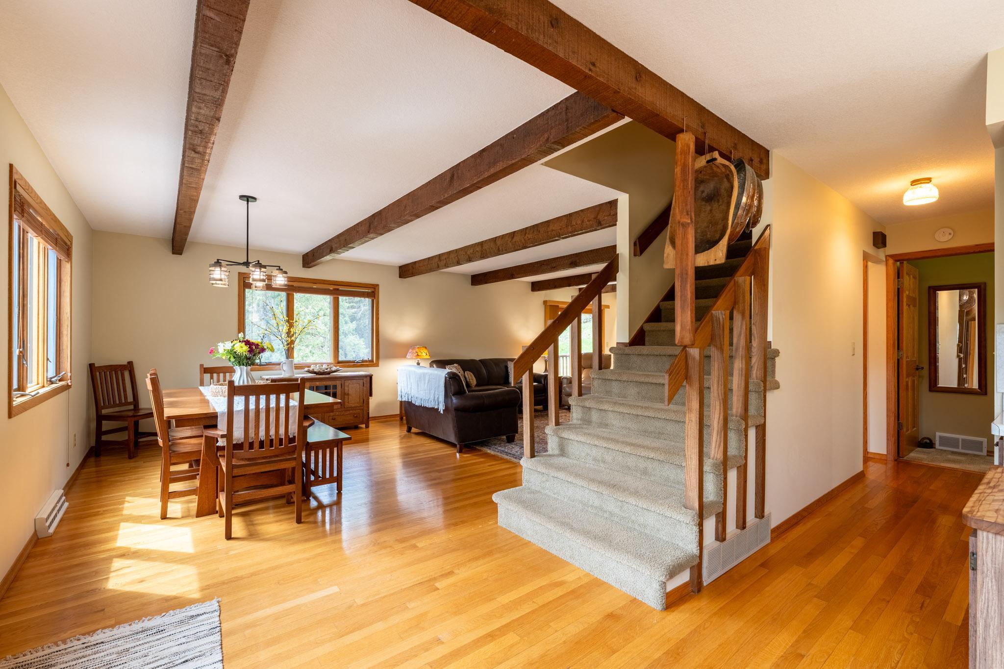 The main level features warm hardwood floors and an open-concept layout connecting the kitchen, informal dining area, and living room—perfect for everyday living and entertaining.