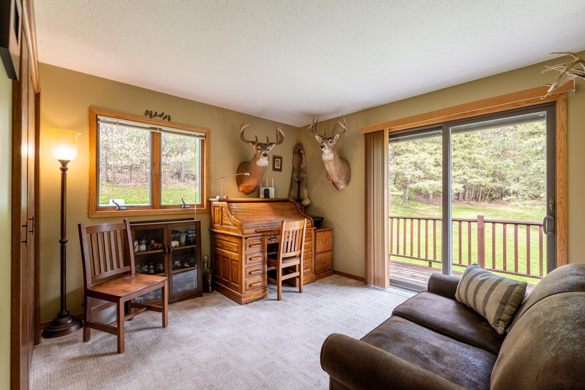 The main level bedroom, currently being used as an office, has it's own sliding glass door (Anderson) out to the wraparound deck.