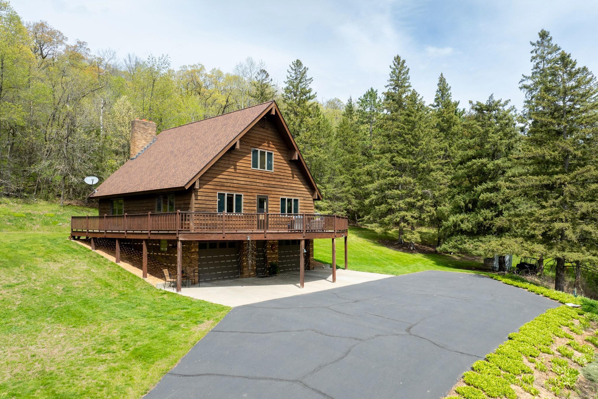 This beautifully maintained custom-built cedar A-frame offers a peaceful retreat on a wooded hillside filled with mature trees and abundant wildlife.