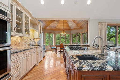 Gourmet kitchen designed for entertaining with premium Thermador and Sub-Zero appliances, custom cabinetry, and oversized center island.