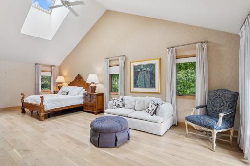 Spacious primary suite featuring vaulted ceilings, skylights, and abundant natural light.