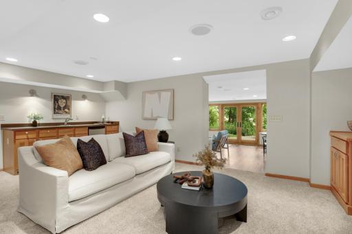 Opposite view of the entertainment space; you can see the wet bar and sunroom in the background.
