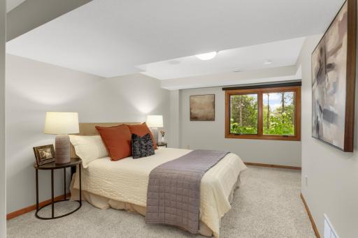 Junior suite bedroom is tucked between den and attached bath.