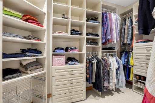 Wonderful custom walk-in closet organizes the primary suite.