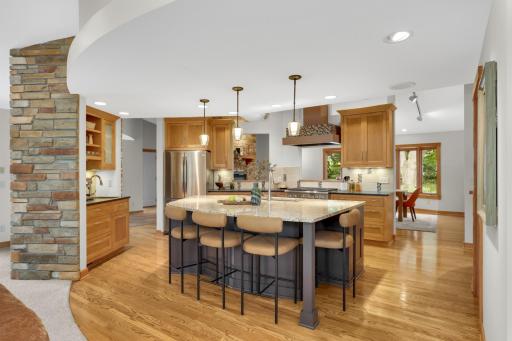 Kitchen view from the lake room, with enormous center island, coffee bar and walk-in pantry