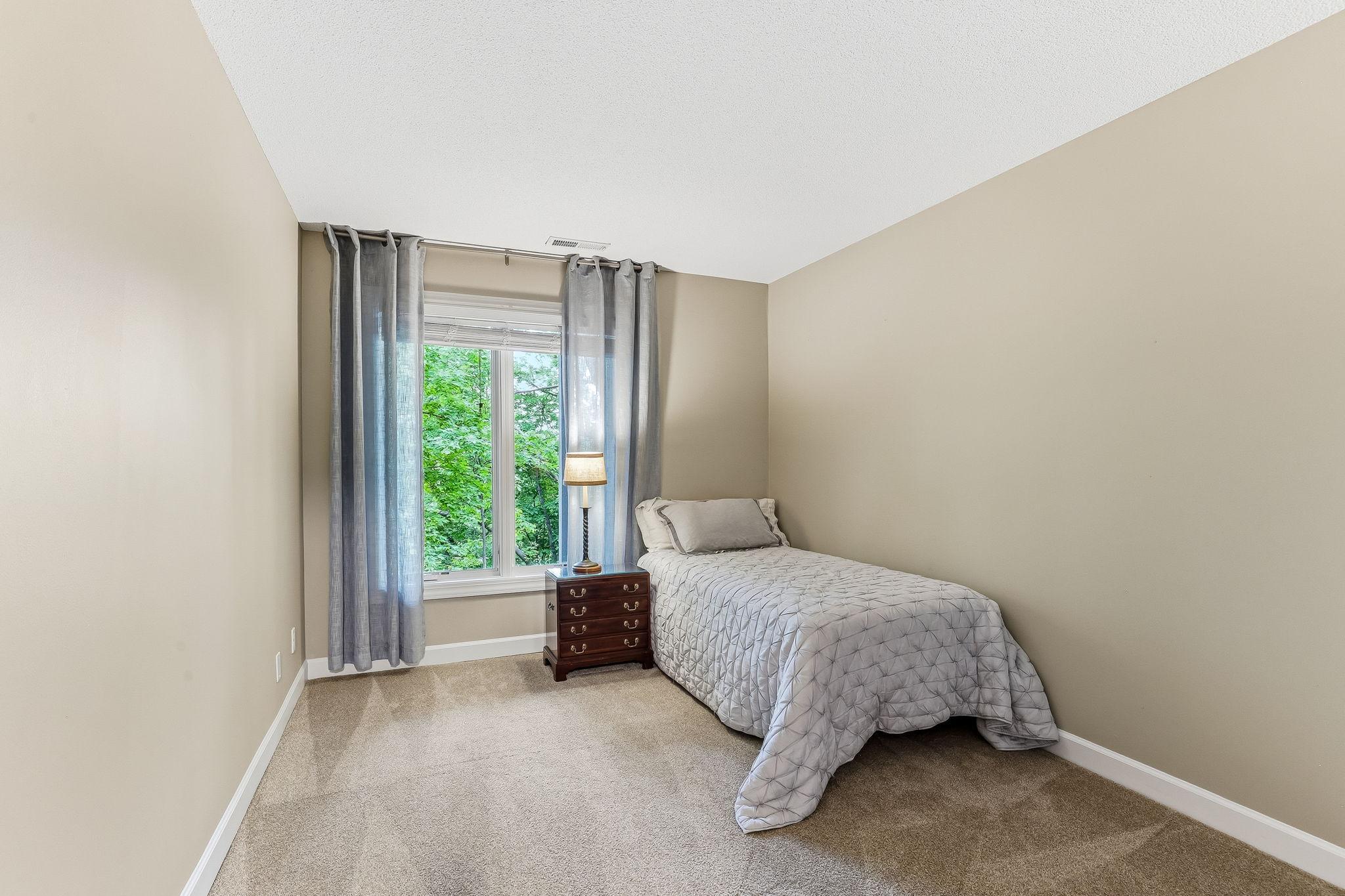 Bright and comfortable second bedroom offering flexible space for guests, work, or daily living.
