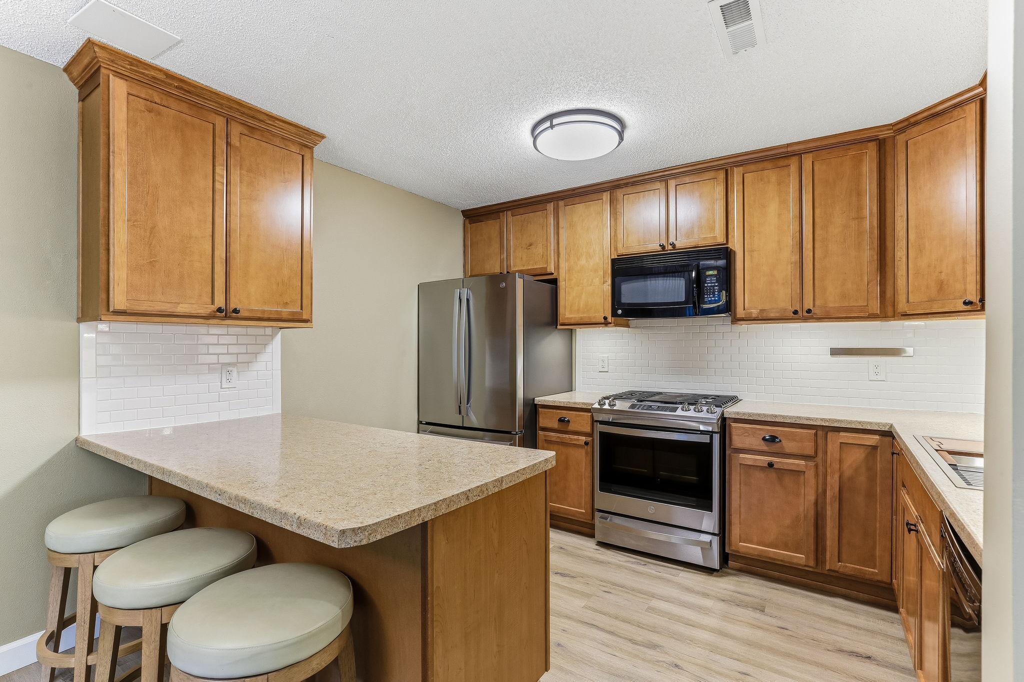A stylish breakfast bar that seamlessly connects the kitchen to the living space, offering a casual spot for morning coffee or quick meals.