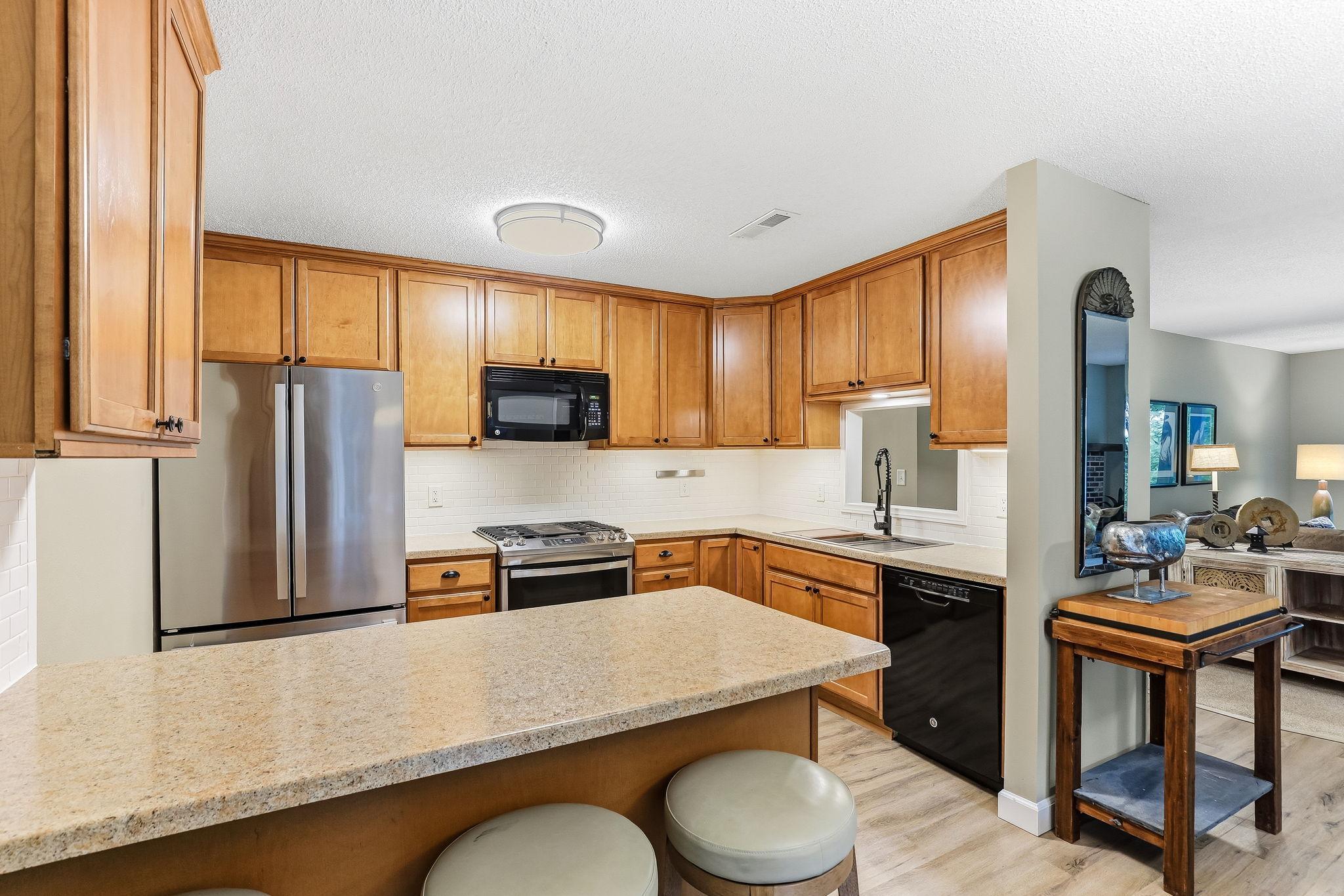Updated kitchen with NEW fridge, stove, sink and faucet (2024) for a fresh, modern feel.