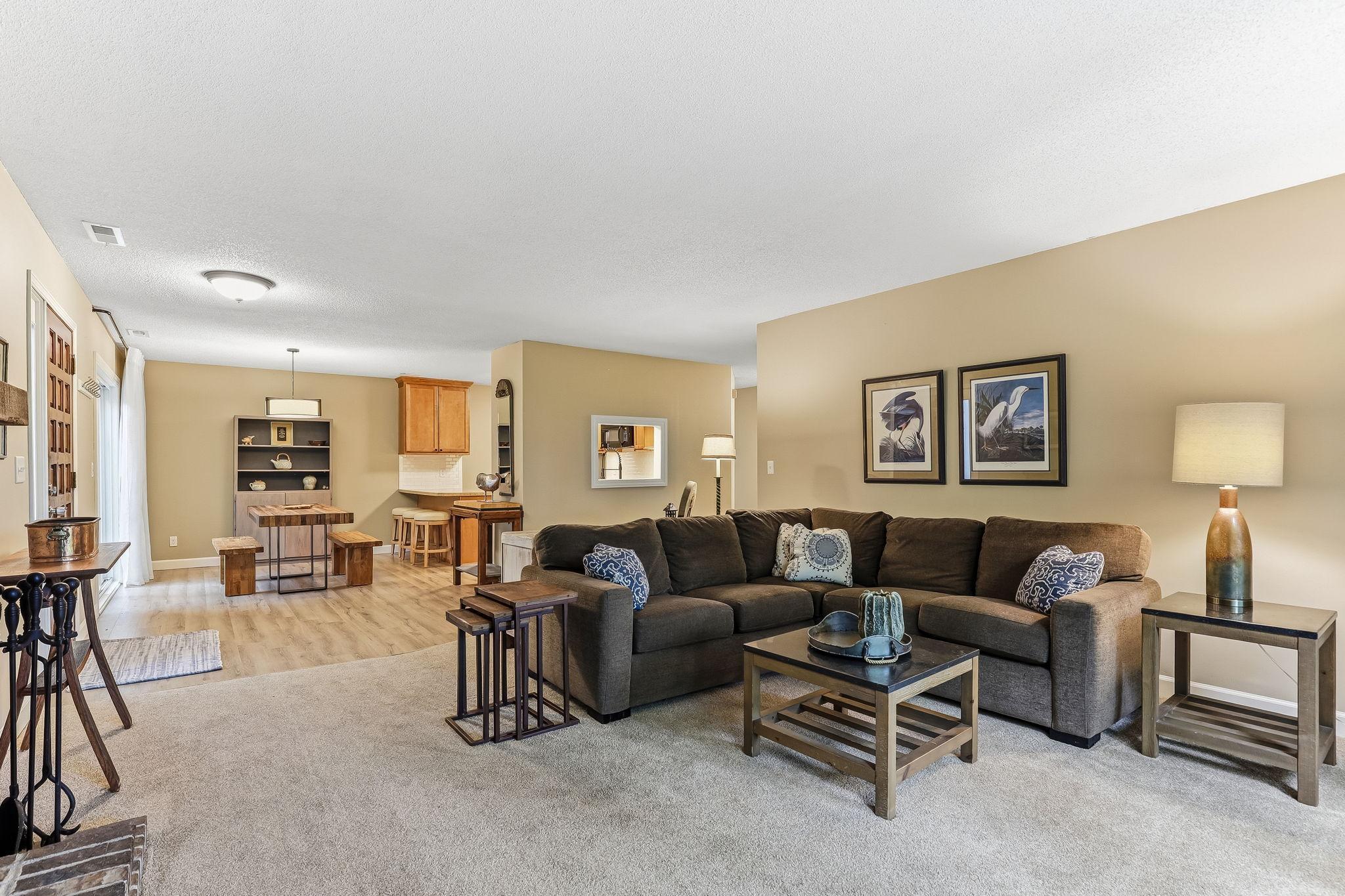A bright, open-concept living and dining area that flows seamlessly into the kitchen, creating a spacious and connected feel.