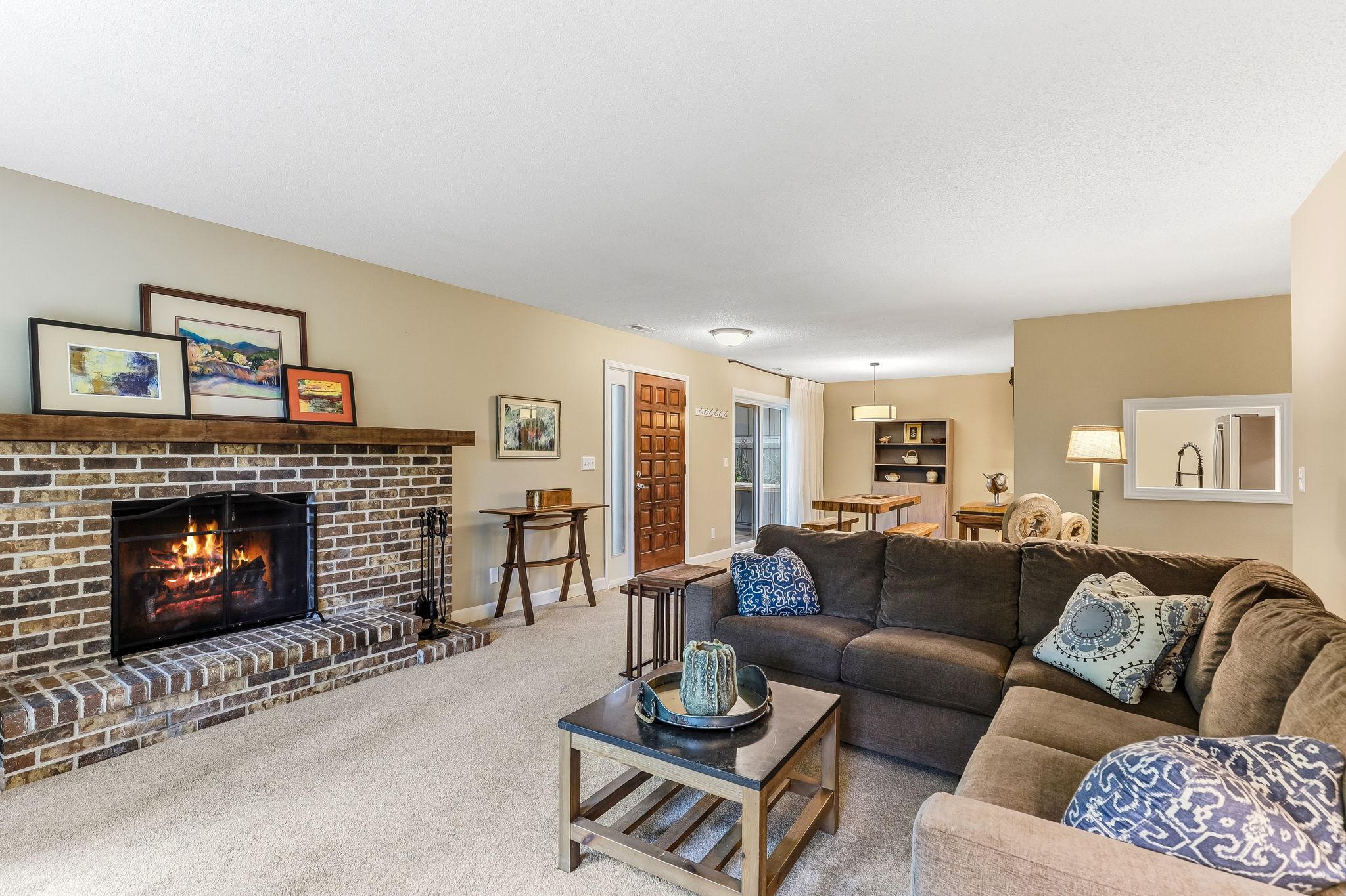 A cozy brick wood-burning fireplace adds warmth, charm, and a classic focal point to the living space.